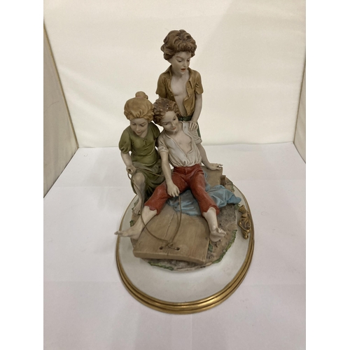 824 - A CAPODIMONTE STYLE FIGURE GROUP OF CHILDREN PLAYING ON A CART