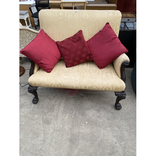 3012 - A MAHOGANY CHIPPENDALE STYLE TWO SEATER SOFA WITH LION MASK DECORATION ON CABRIOLE LEGS WITH CLAW FE...