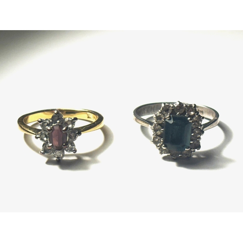 686 - TWO RINGS ONE WHITE METAL WITH BLUE CENTRE STONE SURROUNDED BY CLEAR STONES, THE OTHER YELLOW METAL ... 