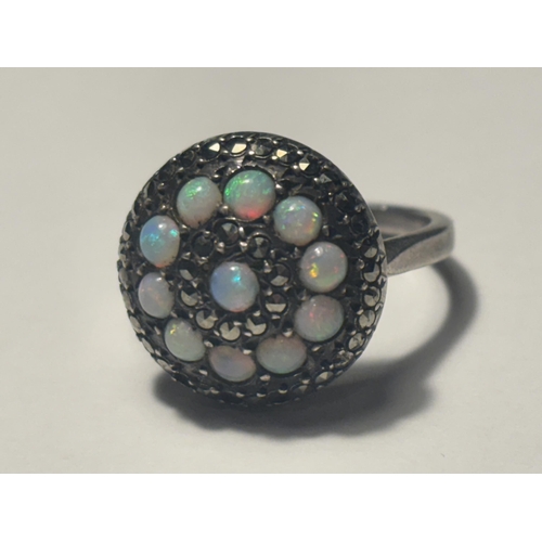 687 - A MARKED SILVER DRESS RING WITH OPALS AND MARCASITE STONES