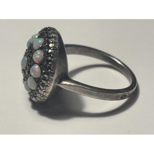 687 - A MARKED SILVER DRESS RING WITH OPALS AND MARCASITE STONES