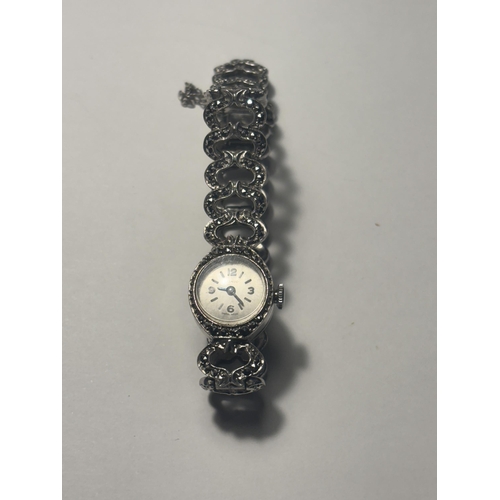 688 - A HALLMARKED LONDON SILVER WRISTWATCH WITH STRAP INSET WITH STONES