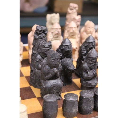 886 - A CHESS BOARD WITH A FULL SET OF MEDIEVAL STYLE CHESS PIECES