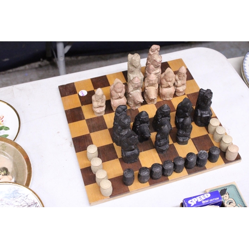 886 - A CHESS BOARD WITH A FULL SET OF MEDIEVAL STYLE CHESS PIECES