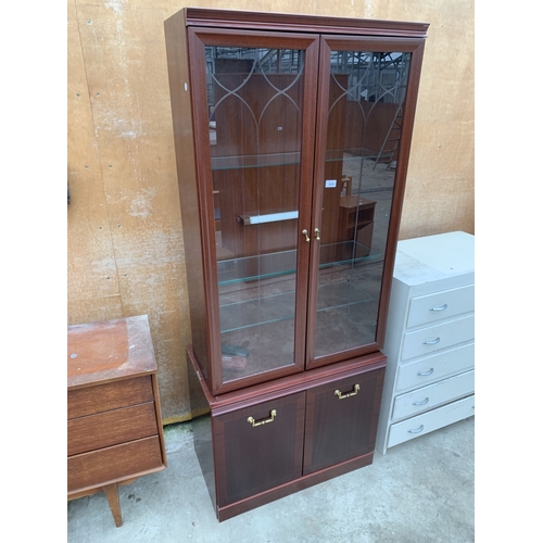 3039 - A MAHOGANY EFFECT TWO DOOR DISPLAY CABINET ON BASE 30