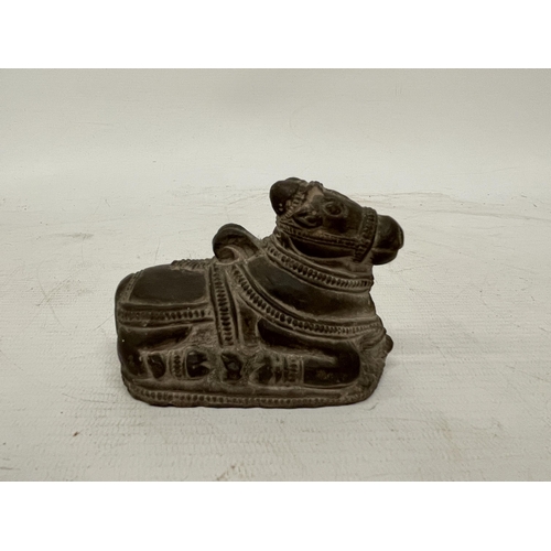 123 - A BLACK STONE NANDI FIGURE TOGETHER WITH A POSSIBLE INDIA GUJARAT FALUS COIN