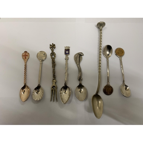 433 - A COLLECTION OF SEVEN DECORATIVE SPOONS AND A PICKLE FORK