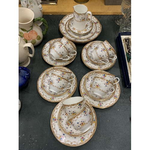 435 - A PART TEA SET 'MADE IN ENGLAND' WITH DECORATIVE GOLD RIM AND FLOWER DECORATION TO INCLUDE TEACUPS, ... 