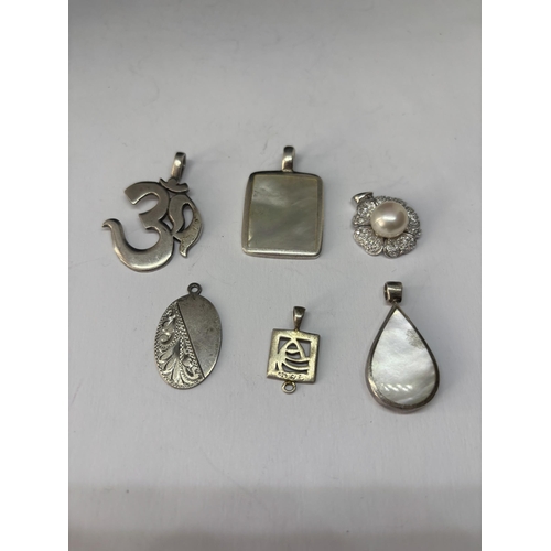 562 - SIX VARIOUS MARKED SILVER PENDANTS