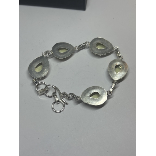 629 - A MARKED 925 SILVER BRACELET WITH LIME GREEN STONES