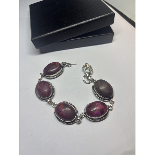 631 - A MARKED 925 SILVER BRACELET WITH PURPLE AND RED STONES IN A PRESENTATION BOX