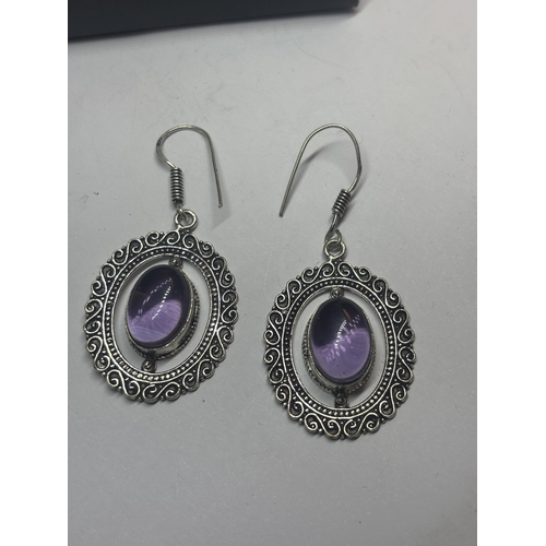 632 - A PAIR OF MARKED 925 SILVER EARRINGS WITH PURPLE STONES IN A PRESENTATION BOX