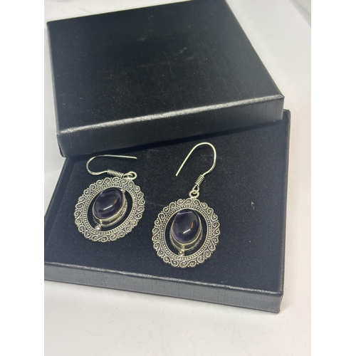 632 - A PAIR OF MARKED 925 SILVER EARRINGS WITH PURPLE STONES IN A PRESENTATION BOX