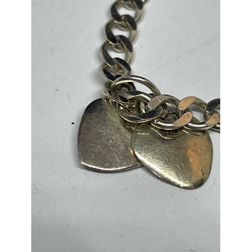 662 - A MARKED SILVER BRACELET WITH DOUBLE HEART, DOUBLE CROSS AND DOUBLE STAR CHARMS