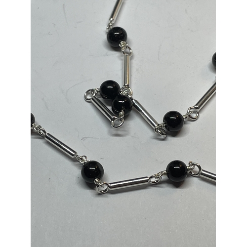 664 - A MARKED SILVER NECKLACE WITH BLACK ONYX BEADS