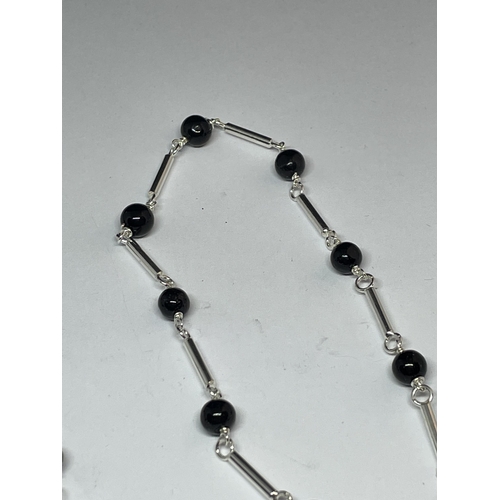 664 - A MARKED SILVER NECKLACE WITH BLACK ONYX BEADS