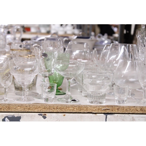 1002 - A VERY LARGE QUANTITY OF DRINKING GLASSES TO INCLUDE GIN, SHERRY, PORT, WINE, ETC., TOGETHER WITH TW... 