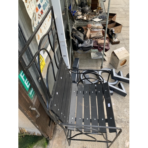 1663 - A LARGE DECORATIVE METAL FRAMED WOODEN SLATTED GARDEN CHAIR