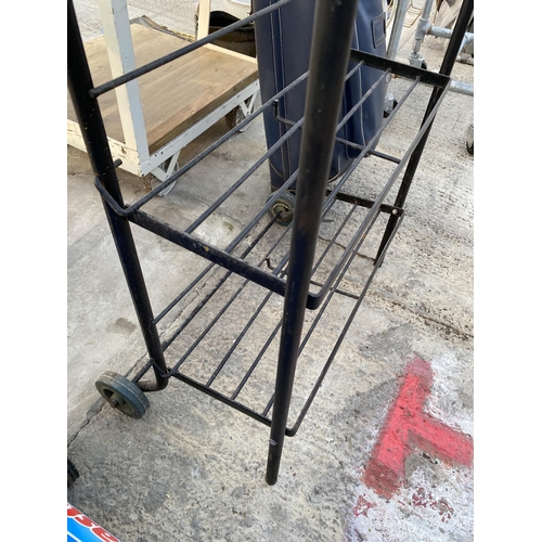 1743 - A METAL THREE TIER SHELVING UNIT WITH TWO WHEELED BASE