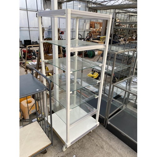 2001 - A METAL AND GLASS SIX TIER RETAIL DISPLAY STAND WITH FOUR WHEELED BASE