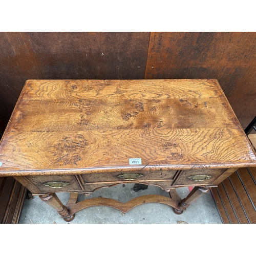 2501 - AN OAK GEORGIAN STYLE RENAISSANCE LOWBOY ENCLOSING THREE DRAWERS WITH TURNED TAPERING CHAMFERRED LEG... 