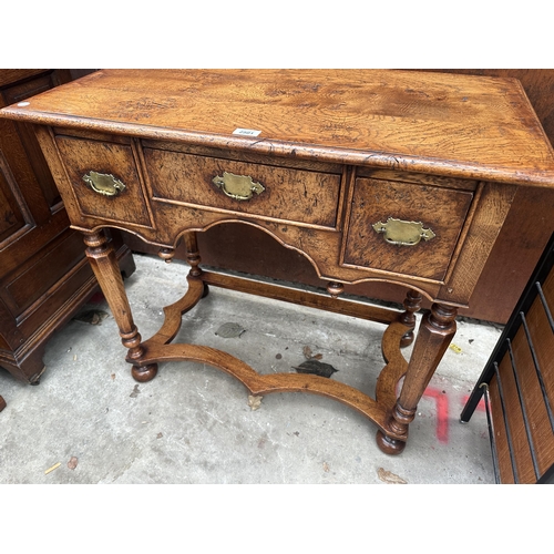 2501 - AN OAK GEORGIAN STYLE RENAISSANCE LOWBOY ENCLOSING THREE DRAWERS WITH TURNED TAPERING CHAMFERRED LEG... 