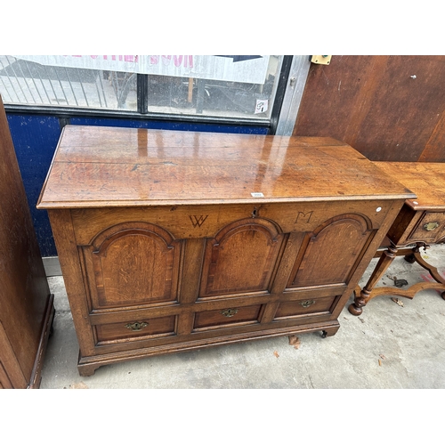 2502 - AN OAK AND CROSSBANDED GEORGE III LANCASHIRE CHEST WITH THREE RAISED PANELS AND THREE DRAWERS BEARIN... 