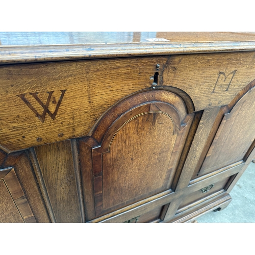 2502 - AN OAK AND CROSSBANDED GEORGE III LANCASHIRE CHEST WITH THREE RAISED PANELS AND THREE DRAWERS BEARIN... 