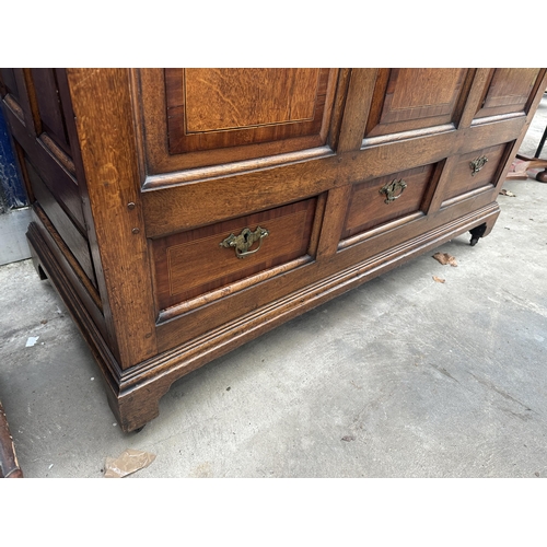 2502 - AN OAK AND CROSSBANDED GEORGE III LANCASHIRE CHEST WITH THREE RAISED PANELS AND THREE DRAWERS BEARIN... 