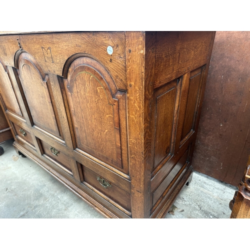 2502 - AN OAK AND CROSSBANDED GEORGE III LANCASHIRE CHEST WITH THREE RAISED PANELS AND THREE DRAWERS BEARIN... 