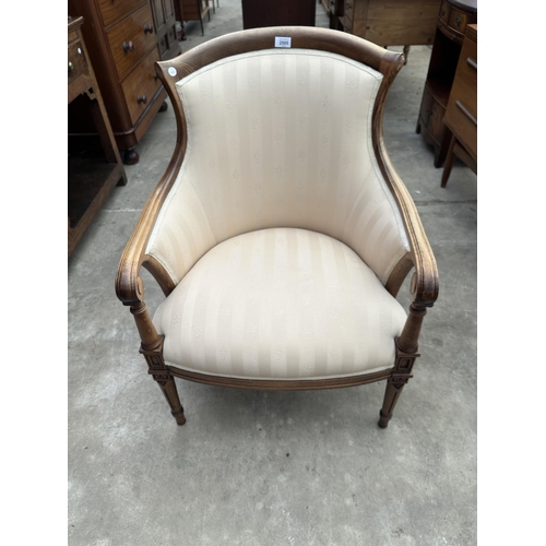 2505 - A LOUIS XVI STYLE LOUNGE CHAIR WITH SCROLL ARMS AND CURVED RACK ON TURNED AND FLUTED TAPERING FRONT ... 