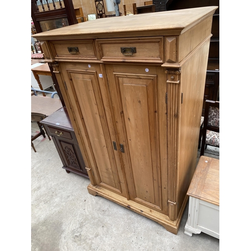 2546 - A PINE TWO DOOR PANELLED BEDROOM CUPBOARD WITH TWO DRAWERS 39