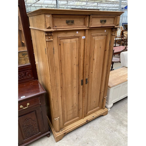 2546 - A PINE TWO DOOR PANELLED BEDROOM CUPBOARD WITH TWO DRAWERS 39