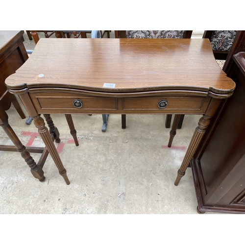 2548 - A MAHOGANY FOLD OVER GAME TABLE WITH TWO SHAM DRAWERS ON TURNED AND FLUTED LEGS 31