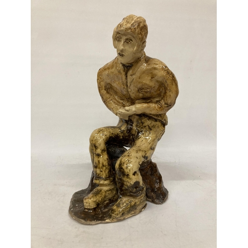 60 - A LARGE GLAZED POTTERY SCULPTURE OF A SEATED MAN, SIGNED FRANCO MONDSTERO, HEIGHT 44CM