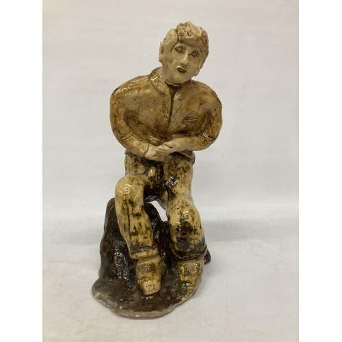 60 - A LARGE GLAZED POTTERY SCULPTURE OF A SEATED MAN, SIGNED FRANCO MONDSTERO, HEIGHT 44CM