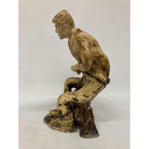 60 - A LARGE GLAZED POTTERY SCULPTURE OF A SEATED MAN, SIGNED FRANCO MONDSTERO, HEIGHT 44CM