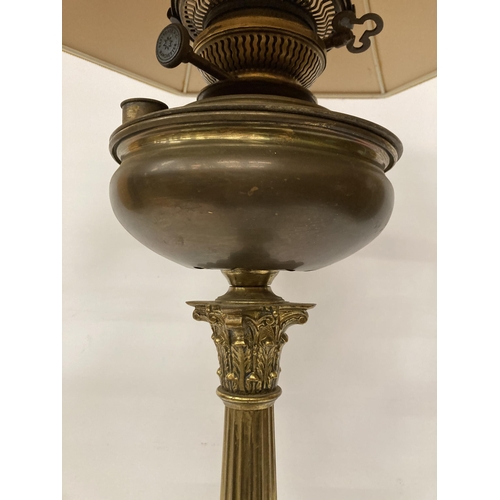 61 - A LARGE BRASS OIL LAMP WITH CORINTHIAN COLUMN, CONVERTED TO ELECTRIC, WITH SHADE, HEIGHT APPROX 64CM