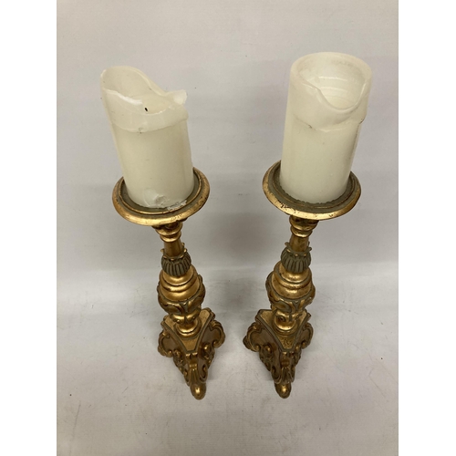 63 - A PAIR OF LARGE, HEAVY WOODEN CANDLESTICKS, ROCOCO STYLE WITH A GILT FINISH, HEIGHT 46CM