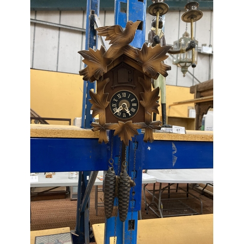 66 - A WEST GERMAN CUCKOO CLOCK WITH PENDULUM AND WEIGHTS