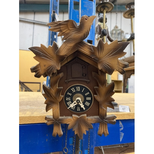 66 - A WEST GERMAN CUCKOO CLOCK WITH PENDULUM AND WEIGHTS