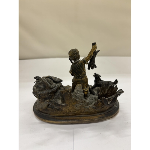 2 - AN ANTIQUE BRASS DESK INKWELL AND PEN STAND MODELLED AS A BOY AND DOG HUNTING, WIDTH 14CM, HEIGHT 10... 