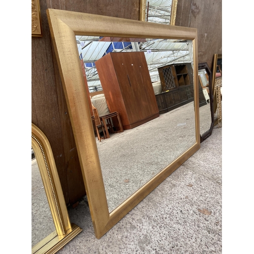 3047 - A LARGE GILT FRAMED WALL MIRROR, 52