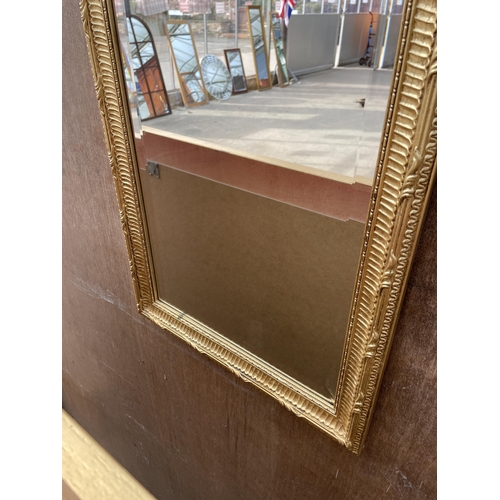 3048 - A GILT FRAMED BEVEL EDGE WALL MIRROR WITH TOP RAIL SHELL DECORATION, 53