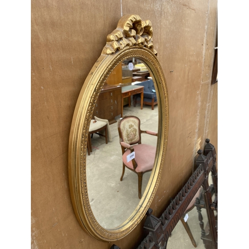 3066 - AN OVAL GILT FRAMED WALL MIRROR, 26