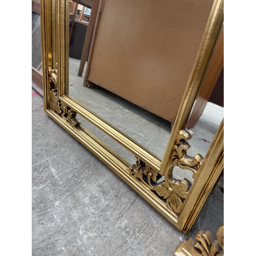 3079 - A GILT FRAMED WALL MIRROR WITH FOLIATE DECORATION, 44