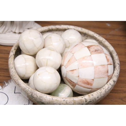 971 - A MARBLE STYLE BOWL CONTAINING A QUANTITY OF DECORATIVE BALLS AND AN ITALIAN FAMILY FIGURE GROUP