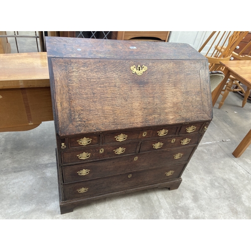 3169 - A GEORGE III OAK BUREAU WITH FITTED INTERIOR AND SEVEN DRAWERS TO BASE ON BRACKET FEET 36