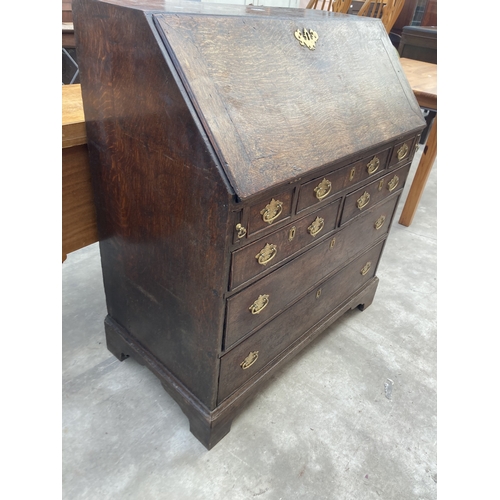 3169 - A GEORGE III OAK BUREAU WITH FITTED INTERIOR AND SEVEN DRAWERS TO BASE ON BRACKET FEET 36