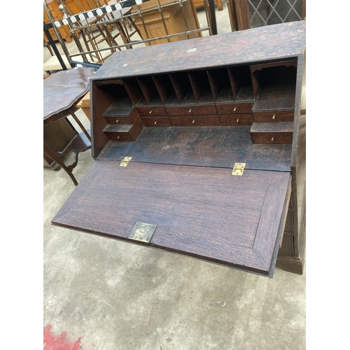 3169 - A GEORGE III OAK BUREAU WITH FITTED INTERIOR AND SEVEN DRAWERS TO BASE ON BRACKET FEET 36